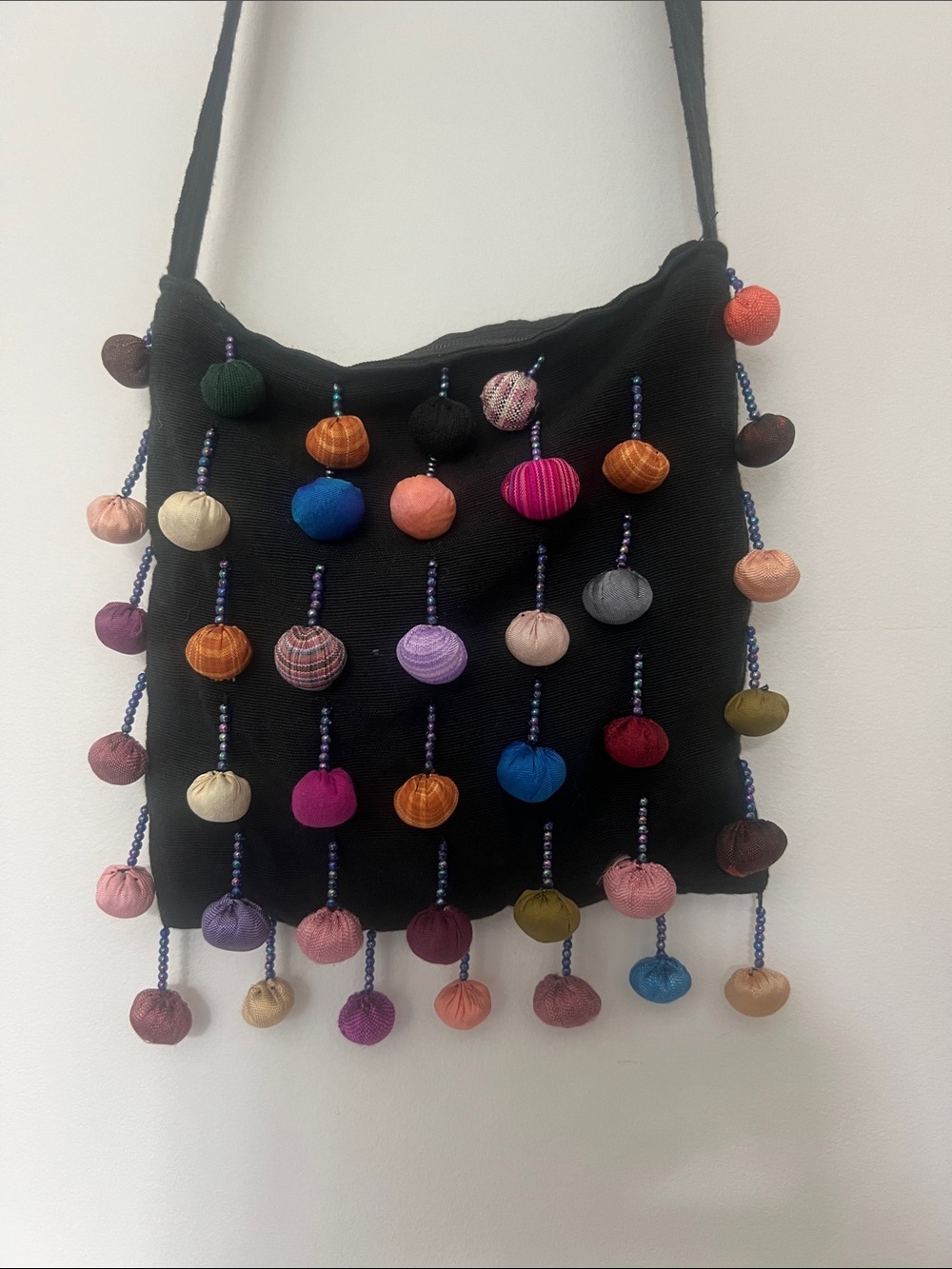 Handcrafted Sling Bag with Colorful Pom-Pom Accents